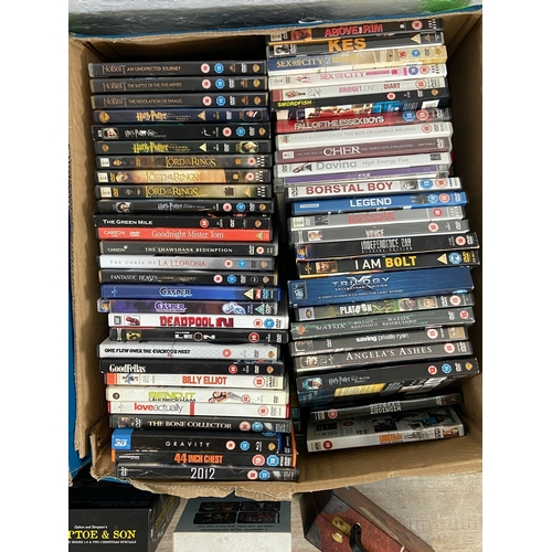 748A - Three boxes of DVDs contains a wide variety of movies and TV shows to include Friends complete serie... 