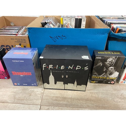 748A - Three boxes of DVDs contains a wide variety of movies and TV shows to include Friends complete serie... 