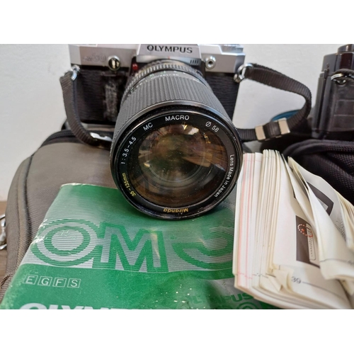 675 - Five Olympus 35mm SLR cameras, one OM30 with instruction manual, three OM40 Program and one OM101 Po... 