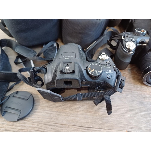 678 - Four Fujifilm FinePix 14mp digital bridge cameras, one SL245, one S2950 and two S4300