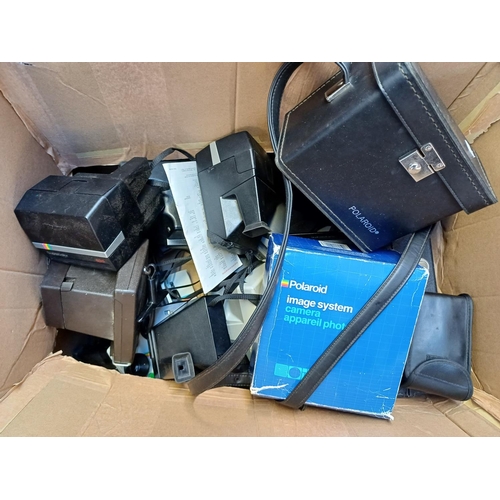 690 - A box containing Polaroid cameras