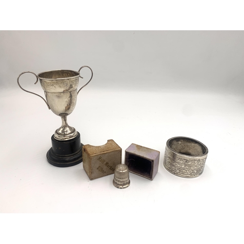 2222 - Three hallmarked sterling silver items, one napkin ring, one boxed thimble and one trophy on stand -... 