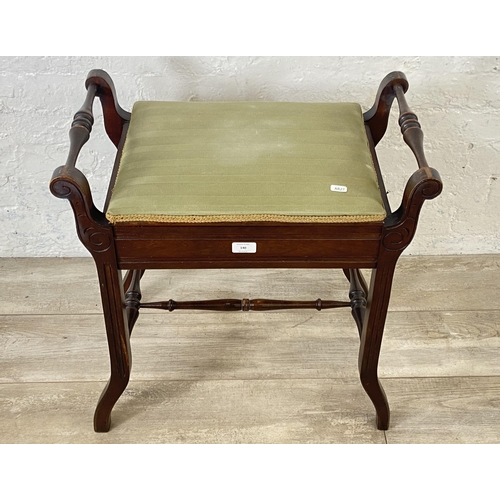 140 - An Edwardian mahogany and green fabric upholstered twin handled piano stool - approx. 60cm high x 58... 