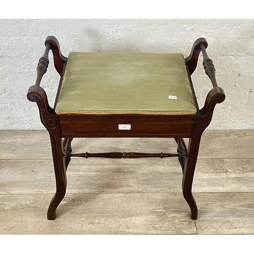 140 - An Edwardian mahogany and green fabric upholstered twin handled piano stool - approx. 60cm high x 58... 