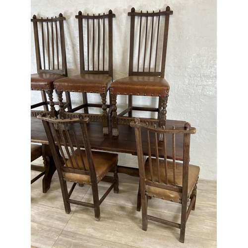 215A - A Nigel Griffiths carved oak dining table and six leather chairs - table approx. 72cm high x 74cm wi... 