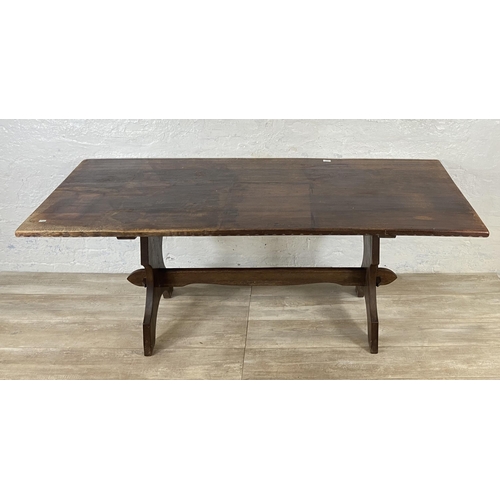 215A - A Nigel Griffiths carved oak dining table and six leather chairs - table approx. 72cm high x 74cm wi... 