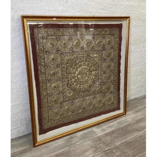 275A - A mid/late 20th century gilt framed Indian sequin and silk embroidered wall hanging - approx. 130cm ... 