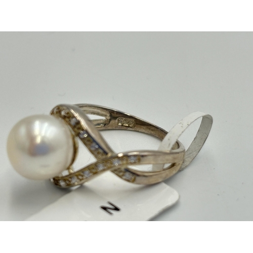 2168 - Two .925 silver CZ and pearl dress rings, one size M and one size N - approx. gross weight 7.2g