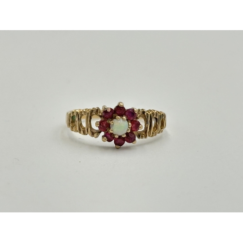 2189 - A hallmarked London 9ct gold ruby and opal ring with textured shoulders, size O - approx. gross weig... 