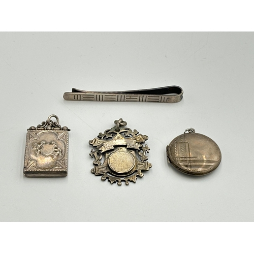 2208 - Four hallmarked sterling silver items, two lockets, one tie clip and one fob - approx. gross weight ... 