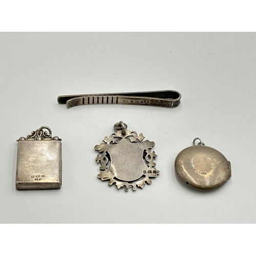 2208 - Four hallmarked sterling silver items, two lockets, one tie clip and one fob - approx. gross weight ... 