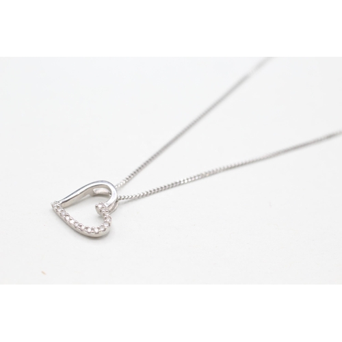 2114 - A 9ct gold diamond heart pendant on chain - approx. gross weight 2g