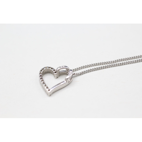 2114 - A 9ct gold diamond heart pendant on chain - approx. gross weight 2g