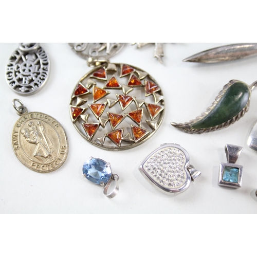 2160 - A collection of sterling silver pendants to include St. Christopher, mother of pearl, CZ heart shape... 