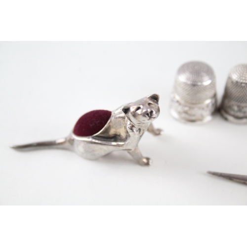 2297 - Eight .925 silver sewing accessories to include six thimbles, novelty pin cushion etc. - approx. gro... 