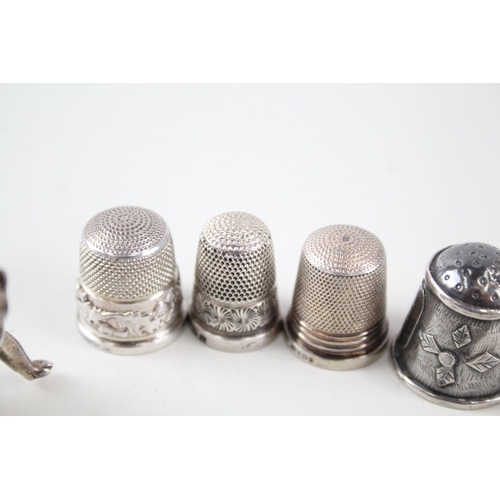 2297 - Eight .925 silver sewing accessories to include six thimbles, novelty pin cushion etc. - approx. gro... 