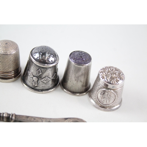 2297 - Eight .925 silver sewing accessories to include six thimbles, novelty pin cushion etc. - approx. gro... 