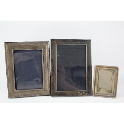 2309 - Three hallmarked sterling silver photo frames - largest approx. 18.5cm high x 14cm wide