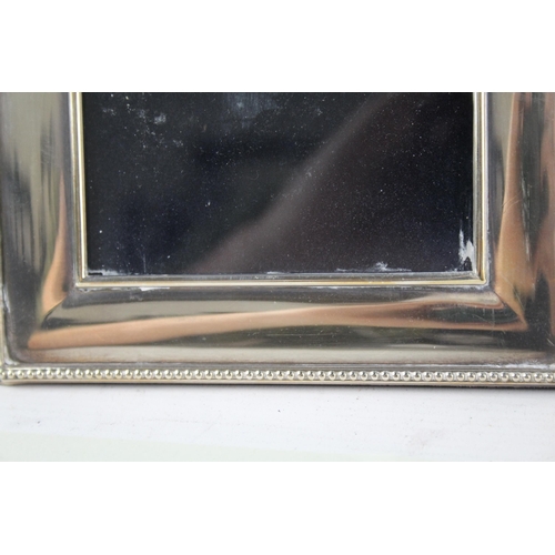 2312 - Three hallmarked sterling silver photo frames - largest approx. 20cm high x 15cm wide