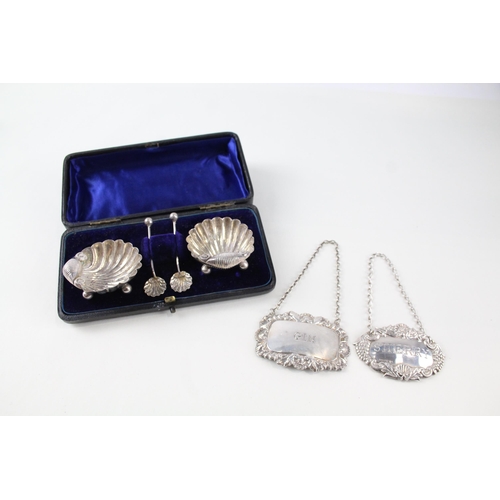 2323 - Six .925 sterling silver items, two decanter labels and a pair of cased shell shaped condiment dishe... 