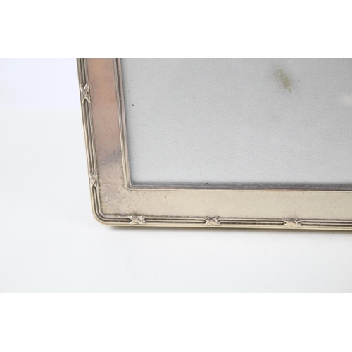 2325 - Three hallmarked sterling silver photograph frames - largest approx. 21.5cm high x 16cm high