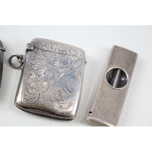 2330 - Four pieces of antique hallmarked silver, three vesta cases and one cigar cutter - approx. gross wei... 