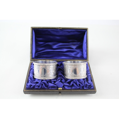 2333 - A pair of cased antique hallmarked silver napkin rings - approx. gross weight 60g