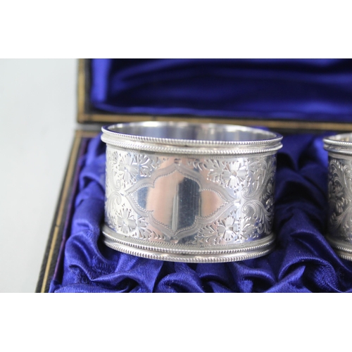 2333 - A pair of cased antique hallmarked silver napkin rings - approx. gross weight 60g