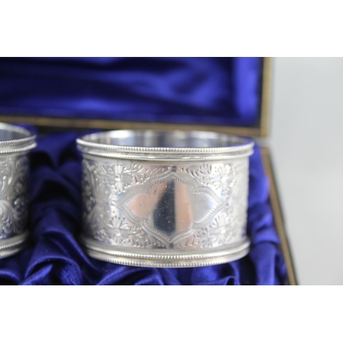 2333 - A pair of cased antique hallmarked silver napkin rings - approx. gross weight 60g