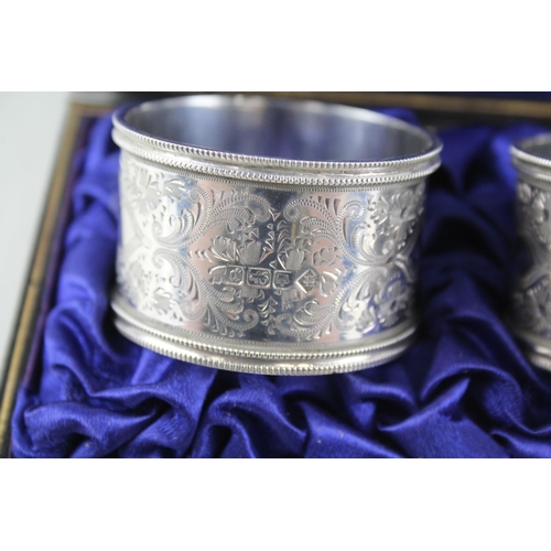 2333 - A pair of cased antique hallmarked silver napkin rings - approx. gross weight 60g