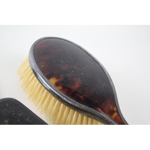 2334 - Four .925 sterling silver and faux tortoiseshell vanity accessories, three brushes and one mirror