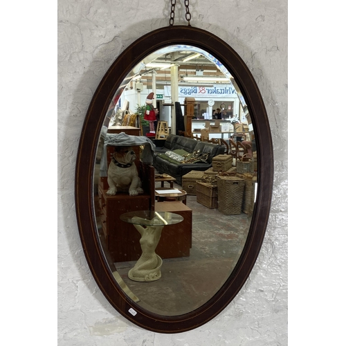 39 - An Edwardian inlaid mahogany framed bevelled edge oval wall mirror - approx. 92cm high x 60cm wide