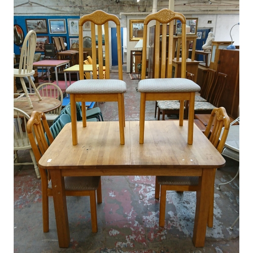 73 - Five pieces of furniture, one oak extending dining table and four beech framed dining chairs