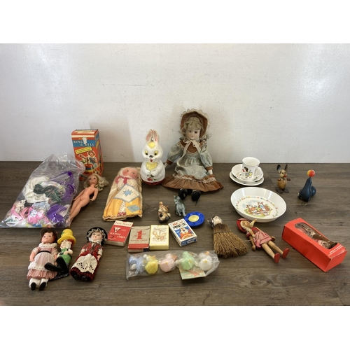 428 - A collection of items to include vintage boxed Merit Ring A Bell, porcelain headed doll, Sindy doll,... 