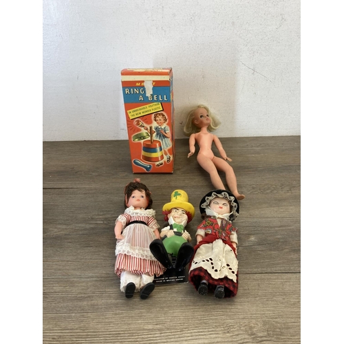 428 - A collection of items to include vintage boxed Merit Ring A Bell, porcelain headed doll, Sindy doll,... 