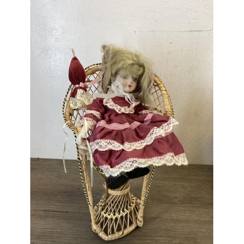 433 - Three porcelain headed dolls together with 1970s style wicker peacock chair