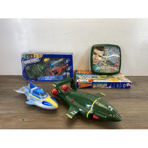 459 - A collection of Thunderbirds toys and collectables to include International Rescue game, Four Piece ... 