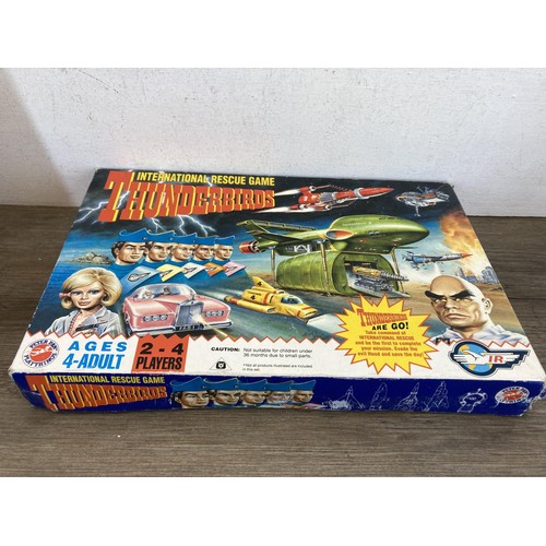 459 - A collection of Thunderbirds toys and collectables to include International Rescue game, Four Piece ... 