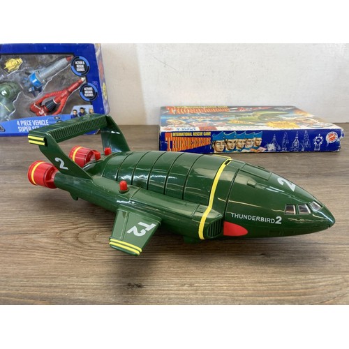 459 - A collection of Thunderbirds toys and collectables to include International Rescue game, Four Piece ... 