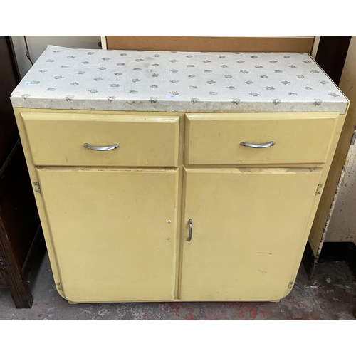 84 - A 1950s yellow painted kitchen cabinet with contents - approx. 90cm high x 91cm wide x 45cm deep