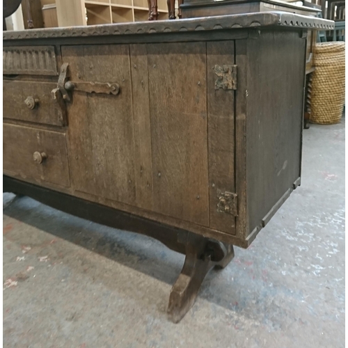 110 - A Nigel Griffiths carved oak sideboard - approx. 76cm high x 168cm wide x 46cm deep