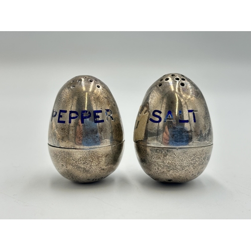 2346 - A pair of Victorian hallmarked London silver and blue enamel novelty egg shaped salt and pepper pots... 