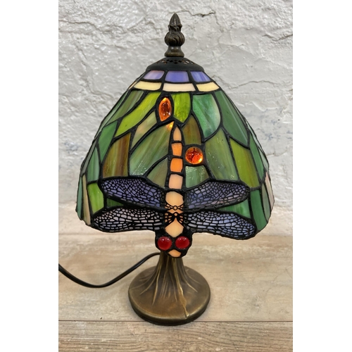 10 - A Tiffany style stained glass and bronze effect Dragonfly table lamp - approx. 30cm high