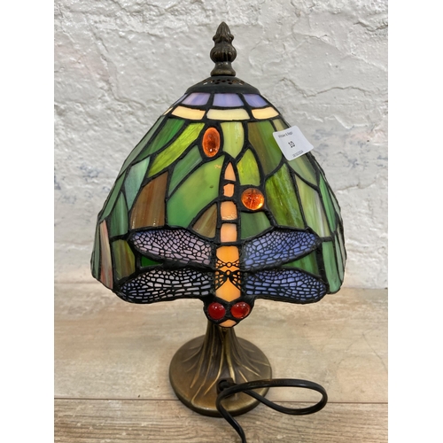 10 - A Tiffany style stained glass and bronze effect Dragonfly table lamp - approx. 30cm high