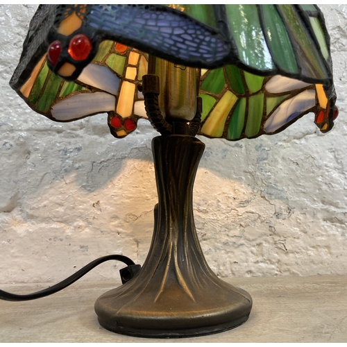 10 - A Tiffany style stained glass and bronze effect Dragonfly table lamp - approx. 30cm high