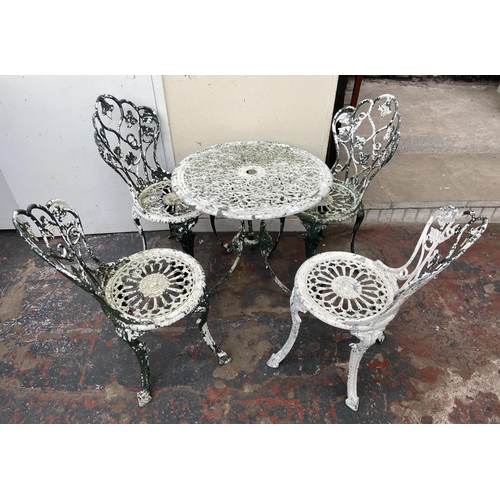 100 - A Victorian style cast metal five piece patio set comprising circular table and four chairs - table ... 