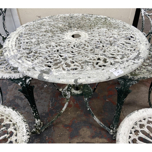 100 - A Victorian style cast metal five piece patio set comprising circular table and four chairs - table ... 