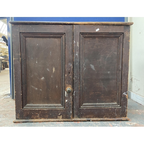 100A - A Victorian stained pine two door cabinet - approx. 80cm high x 94cm wide x 38cm deep