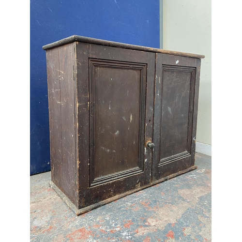 100A - A Victorian stained pine two door cabinet - approx. 80cm high x 94cm wide x 38cm deep