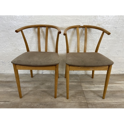 23 - A pair of Artenara wishbone style oak bentwood and fabric upholstered dining chairs